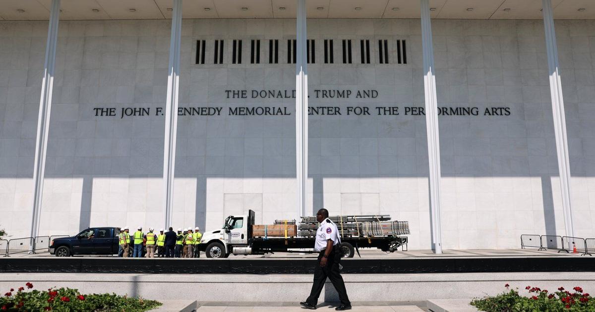 Workers begin to remove Trump's name from the Kennedy Center, in photos