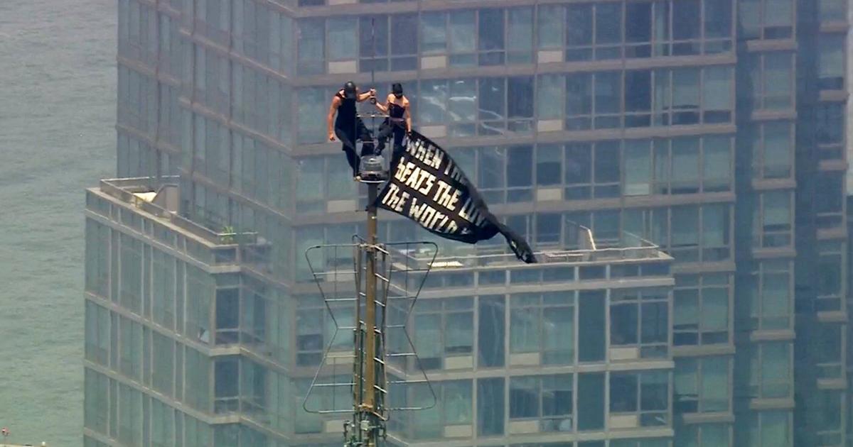 2 people arrested after hanging a banner about 'the power of love' on Empire State Building antenna